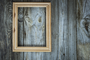 empty wooden frame on aged gray wooden wall