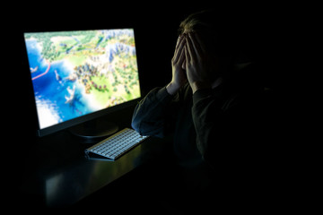 Young gamer in the dark