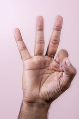 Hand making ok sign, three fingers.