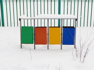 colorful trash cans in the snow