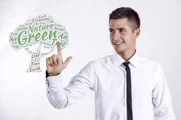 Green Tree - Young businessman touching word cloud