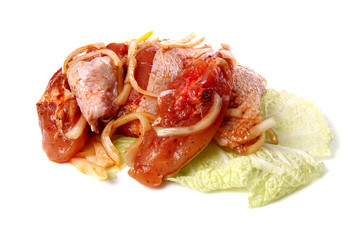 Raw sliced meat on a cabbage leaf