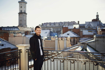 handsome man standing on the terrace with beautiful views