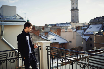 handsome man standing on the terrace with beautiful views