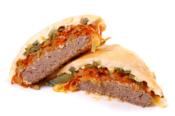 Fried meat covered with cheese, eggs and vegetables