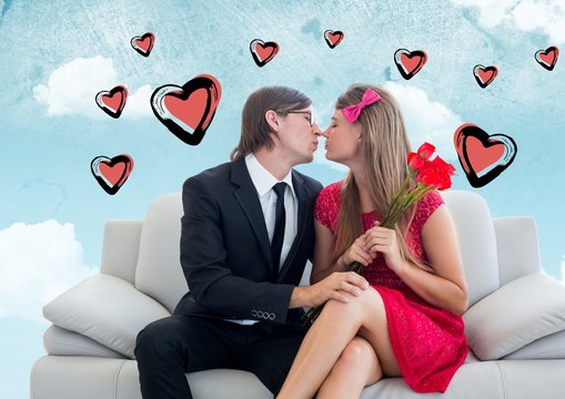 Composite image of romantic couple kissing on sofa