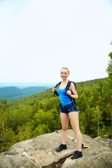 Naklejka premium woman with backpack hiking in the mountains