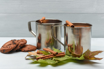 chocolate cookies and mulled wine with cinnamon in metallic mug