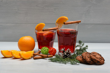 tea or mulled wine with cinnamon, orange, pinecone at christmas