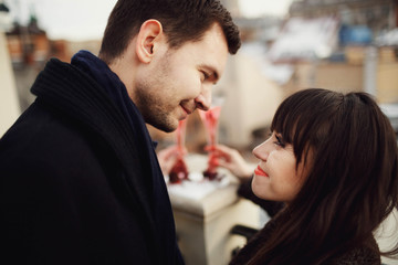 happy man and woman look at each other outdoors
