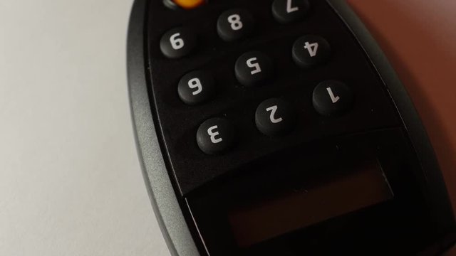 Internet Banking secure pin generator turning on a white background, close-up