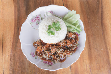 Close up thai sweet braised pork with sesame ราดข้าว.