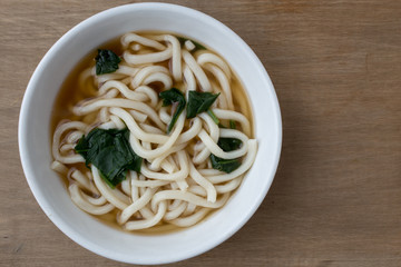 Bowl of udon noodle soup from above.