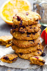 Homemade  pumpkin and orange cookies on rustic wooden background