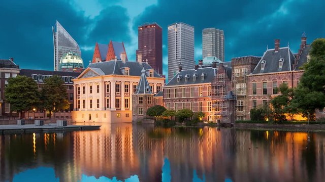 Evening view on Binnenhof Palace and high modern buildings in Hague (static image with animated sky and water)
