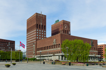Fototapeta na wymiar Oslo City Hall with Norwegian flags. Springtime.