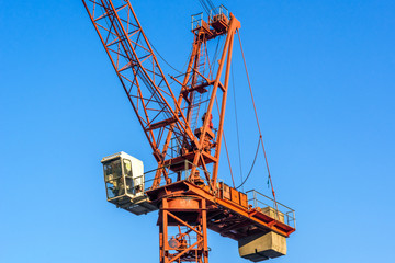 The crane against modern buildings under construction.