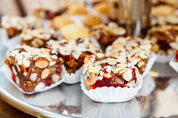 Different candies, cookies and biscuits on banquet table.