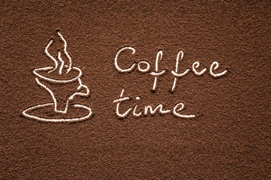 Fototapeta Drawn mug with inscription coffee time created from ground coffee in the kitchen. Enjoying a coffee break.