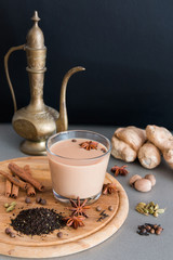 Indian masala tea with different spices and old jug