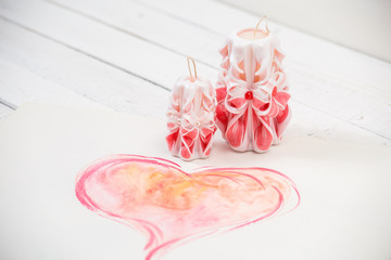 St. Valentine's Day: two pink carved candles, one big  heart.