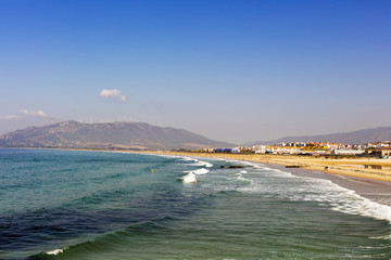 Miles of white sandy beaches of the Atlantic shore at Spanish coast of Playa De Los Lances in Tarifa, Spain.