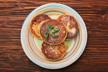 Cheese pancakes fried in a pan.