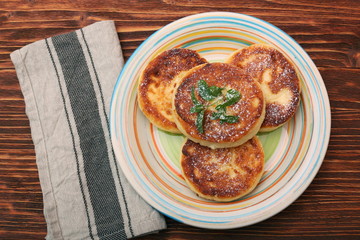 Cheese pancakes fried in a pan.