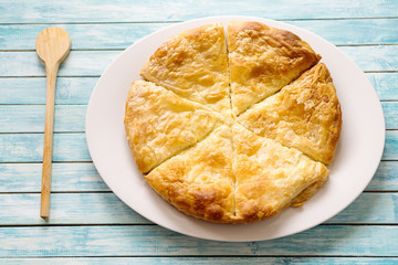 cheese pie on a blue washed table