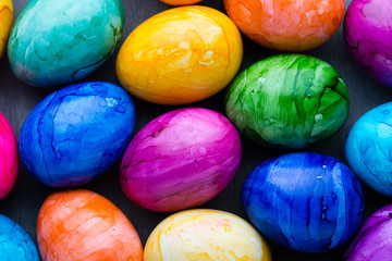 Easter eggs painted in colors on a pattern background.
