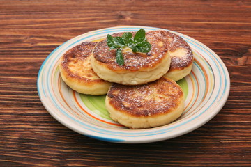 Cheese pancakes fried in a pan.
