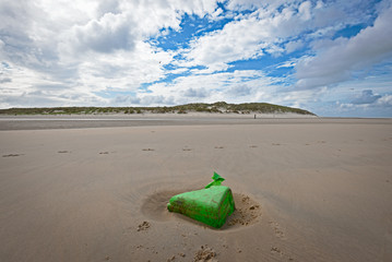 Green plastic garbage on the dutch beach of Vlieland