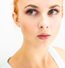 Fototapeta premium Woman with natural make-up eyes and lips on a light background. Close-up