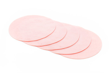 Fototapeta premium Sliced boiled ham sausage isolated on white background, top view