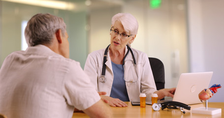 Fototapeta premium Senior doctor talking with elderly man in the office