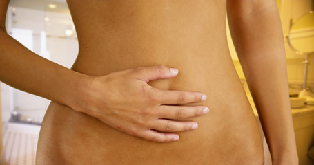 Young white girl having stomach problems in her bathroom