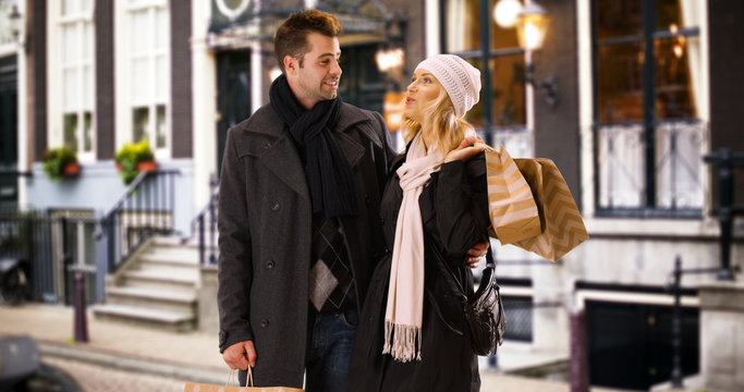 Millenial Couple Standing Outside With Shopping Bags On European Vacation