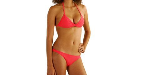 Fototapeta premium African woman in swimwear standing on copyspace.