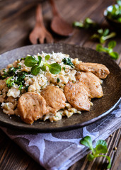 Fried chicken meat with spelt flour dumplings and spinach
