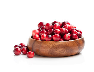 Fresh  cranberries in wooden bowl isolated on white background © lena_zajchikova