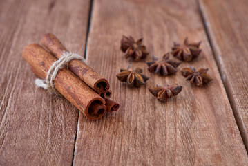 Cinnamon sticks and anise on a wooden background