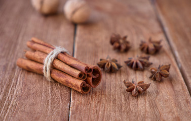 Cinnamon sticks and anise on a wooden background