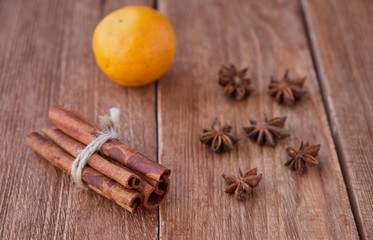 Cinnamon sticks and anise on a wooden background