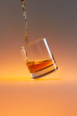 obliquely standing whiskey glass with drops