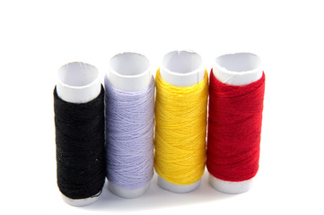 Colorful spools of thread isolated on white background