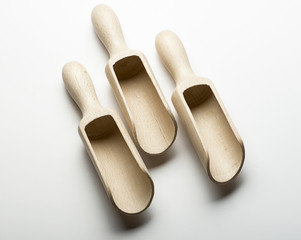 Three wooden spoons on white background. Kitchen equipment.. Horizontal shoot.