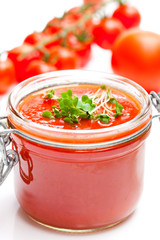 Glass  jar with tomato paste and cherry tomatoes isolated on whi