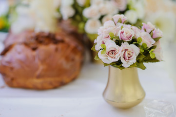 pink roses in a gold vase