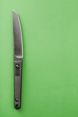 Black knife on yellow background. survival and bushcraft concept