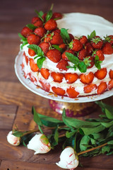 Strawberry cake on a wooden background.
